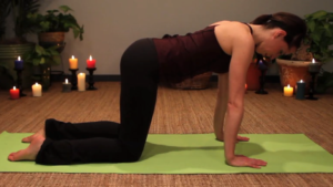 Start of rock back yoga posture