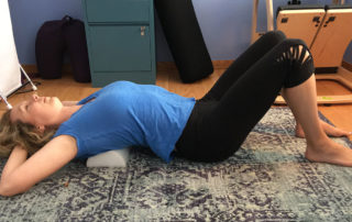 Using a half roller for back stretch