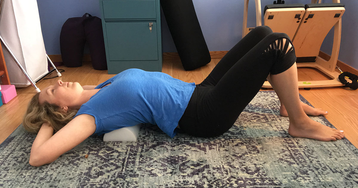 Using a half roller for back stretch