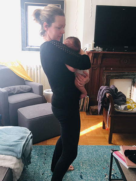 Leaning back while holding a baby
